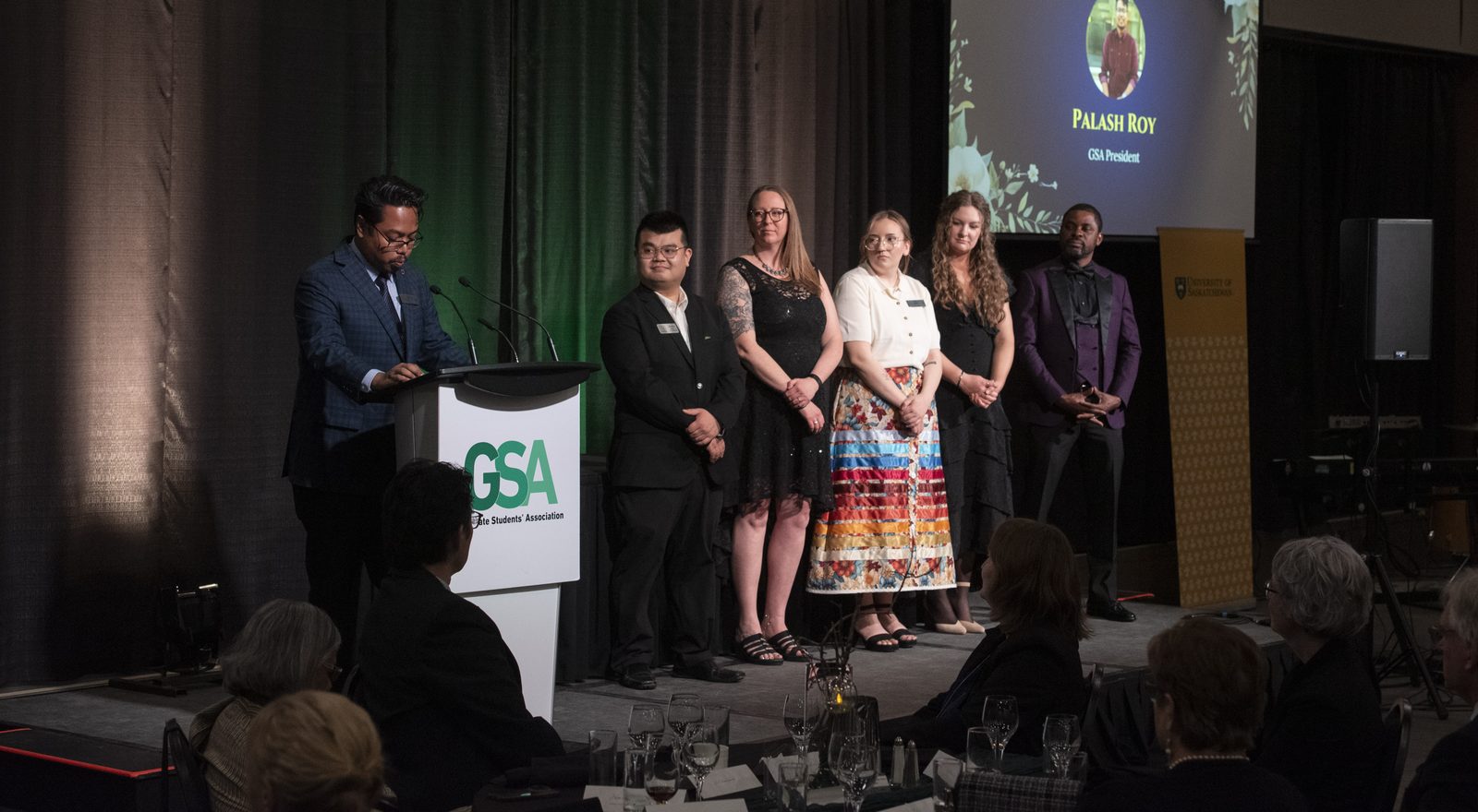 Palash Roy - Recognizing outstanding graduate students on stage during the 2026 GSA Awards & Gala. Palash Ranjan Roy presenting awards to graduate student recipients on stage at the 2026 University of Saskatchewan GSA Awards and Gala